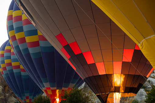 Colorful hot air balloon flying over blue sky with white clouds