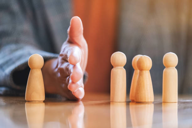 istock a businessman separate one wooden people from a group 1281203760