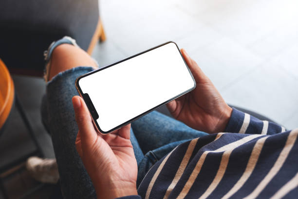istock a woman holding mobile phone with blank white desktop screen 1281204286
