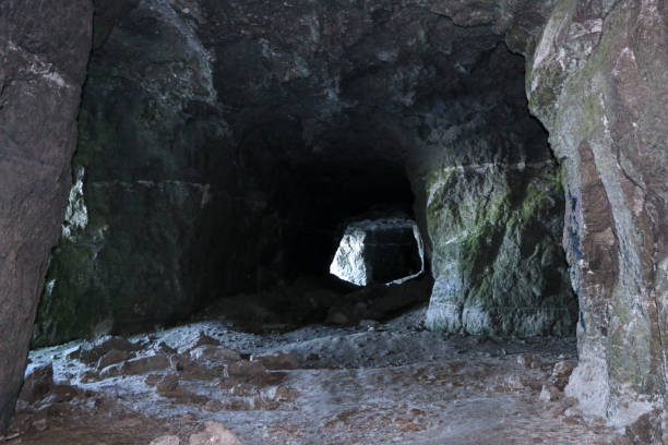 istock old abandoned galleries, adits, for extraction and processing of natural stone and gypsum cave. Dark eerie stone, quartz tunnels deep in  earth. Various rocks, geological and speleological research. 1281204420