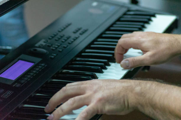 istock pianist hands playing electric piano 1281208035