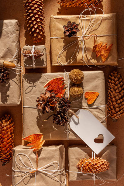 istock Zero waste Christmas knolling flat lay with hard shadows. Hand crafted eco gift, natural New Year jute decorations top view. Kraft paper wrapping without plastic concept. Orange zest tree,hearts,cones 1281208676