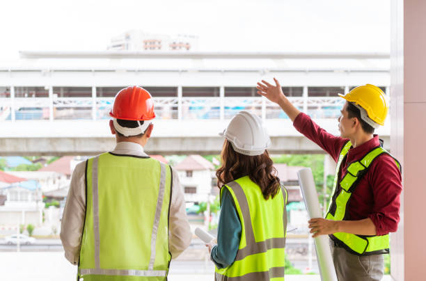 istock Three Civil engineers team with one female is discussing about transporation construction site 1281211490