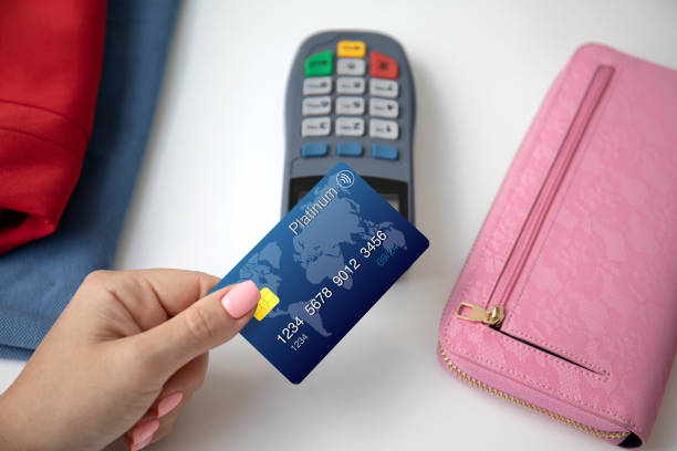 istock woman hand holding plastic card and pay pass online terminal 1281211929