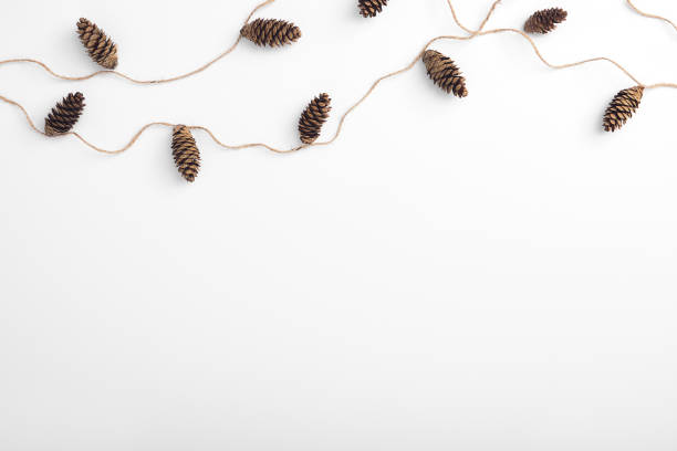 istock Zero waste christmas garland made from pine cone and natural jute twine. Horizontal composition, flat lay, top view. Eco friendly mockup topped with abstract garland 1281213128