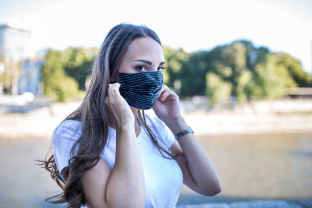 istock Young woman with protective face mask outdoors 1281213390
