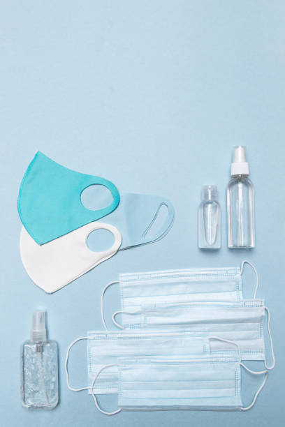 istock Medical face masks, antiseptic, reusable protective face masks on a blue background copy space. Health care concept 1281213473