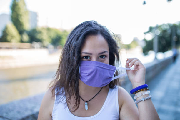 istock Young woman with protective face mask outdoors 1281213489