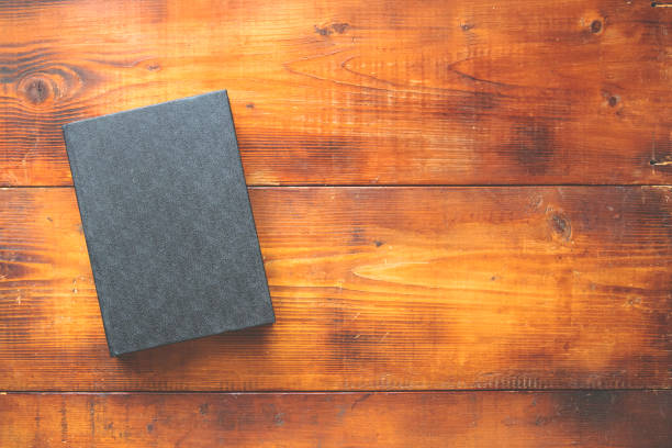 istock black book on a wooden background 1281214723