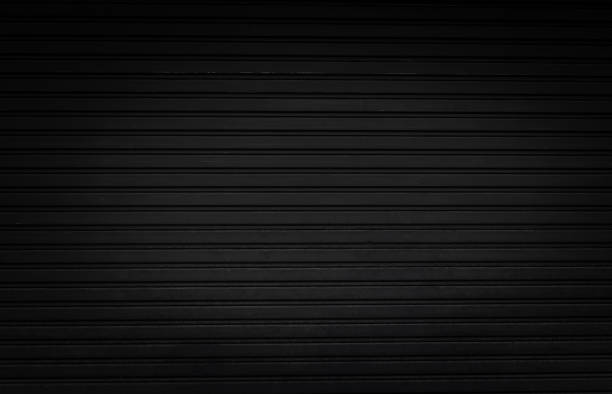 istock grunge black steel shutter door background and texture with vignette effect. 1281215433