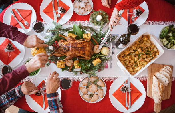istock Cropped hands cutting and takes meat on dining table. 1281215556