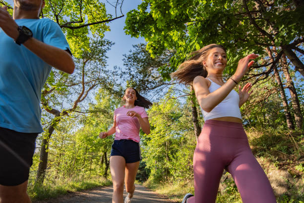 istock Three young people jogging together in nature. 1281219150