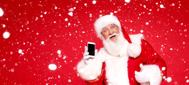 istock Real Santa Claus showing mobile phone screen 1281220387