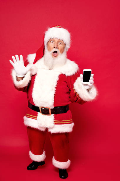 istock Real Santa Claus showing mobile phone screen 1281220446
