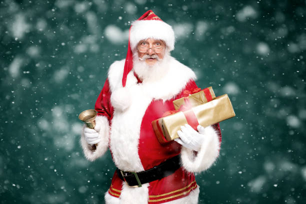 istock Good old Santa Claus holding gift boxes. 1281220670