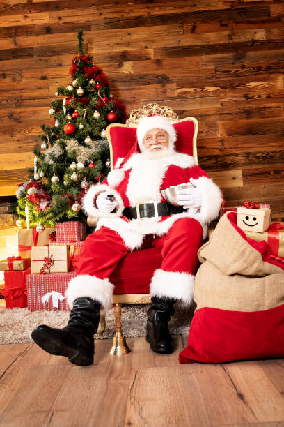 tired santa claus relaxing with popcorn and movie. - remote television movie box imagens e fotografias de stock