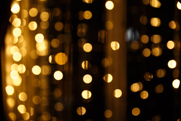 istock Disco lights. Bokeh glows on a dark background. Christmas garlands with a blurred focus in the form of a Golden bokeh. 1281221851