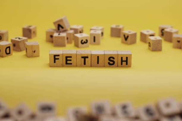 istock FETISH Word Written In Wooden Cube With Yellow Background 1281222273