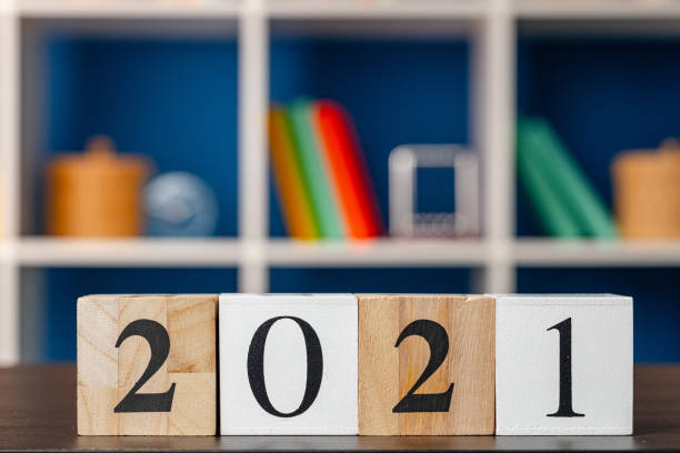 istock Wooden cubes with year 2021 on working table 1281222278
