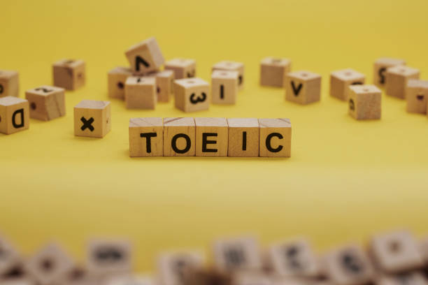 istock TOEIC Word Written In Wooden Cube With Yellow Background 1281222328