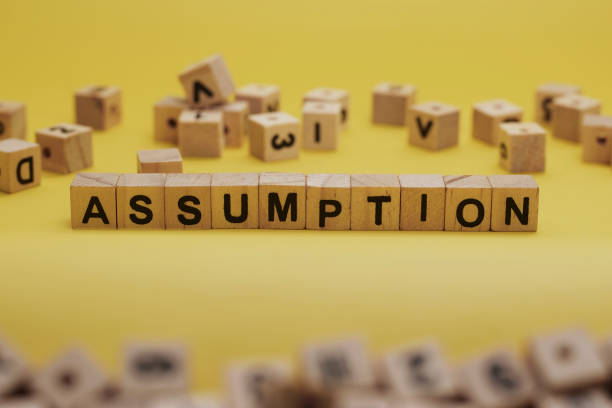istock ASSUMPTION Word Written In Wooden Cube With Yellow Background 1281222546