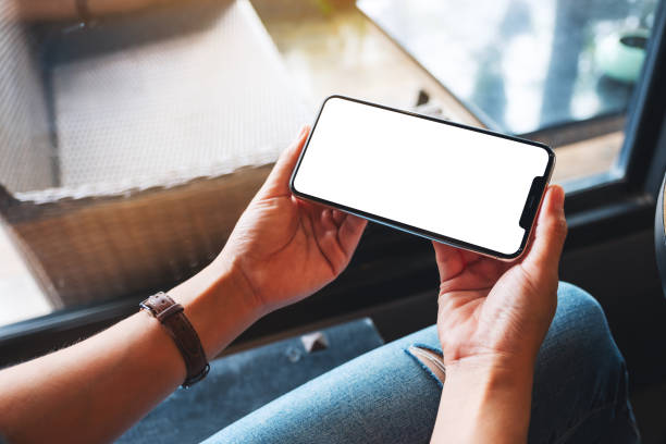 istock a woman holding mobile phone with blank white desktop screen 1281225179