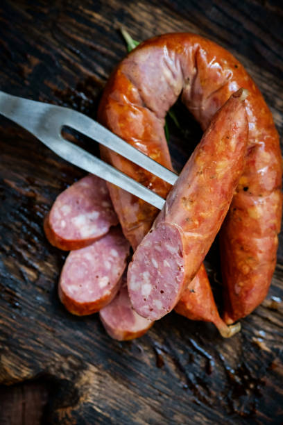 salchichas ahumadas bávaras de cerdo cortadas en una tabla de madera. estilo rústico - sausage knackwurst food bratwurst fotografías e imágenes de stock