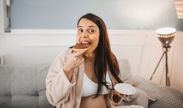 istock A pregnant woman enjoys coffee and donuts 1281226021