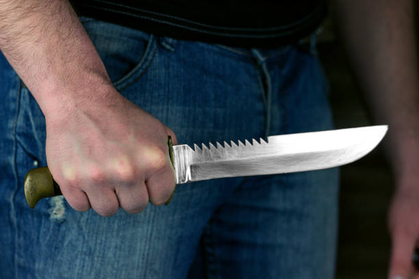 istock man with a knife in his hand in the dark 1281228318
