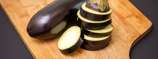 istock Eggplant on wooden cutting board 1281228852