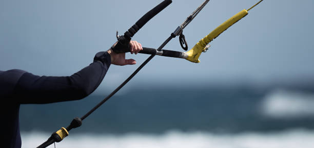 Man kitesurfer ready for kite surfing rides Man kitesurfer ready for kite surfing rides in blue sea kite sailing stock pictures, royalty-free photos & images