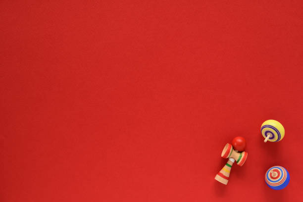 istock Spinning top and Kendama toy on red background. 1281231107