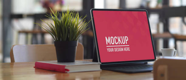 istock Worktable with digital tablet, book and plant pot on wooden table, clipping path 1281231194