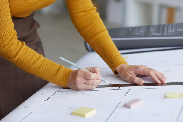 istock Female Architect Drawing Plans Close Up 1281231291