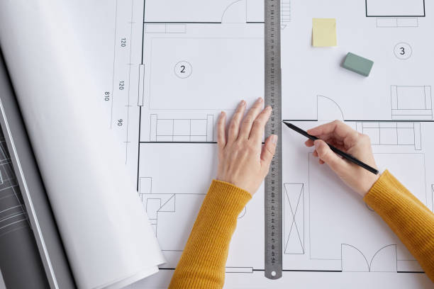 istock Woman Drawing Floor Plans Top View 1281231374