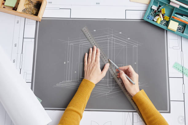 istock Woman Drawing Blueprints Top View 1281231782
