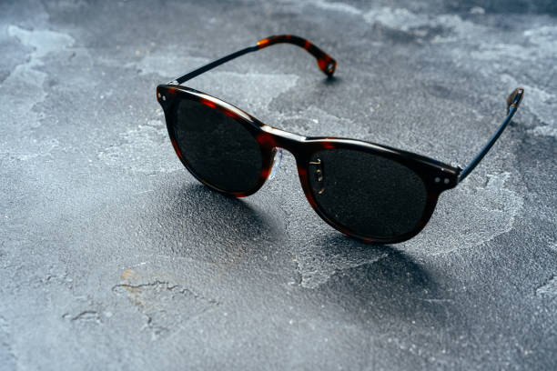 istock Dark male sunglasses on grey concrete surface 1281232316