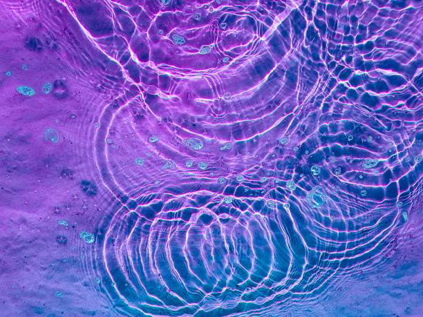 istock Water texture with circular streaks on the surface, bubbles and sun glare. Concept background, texture, abstraction. 1281232346