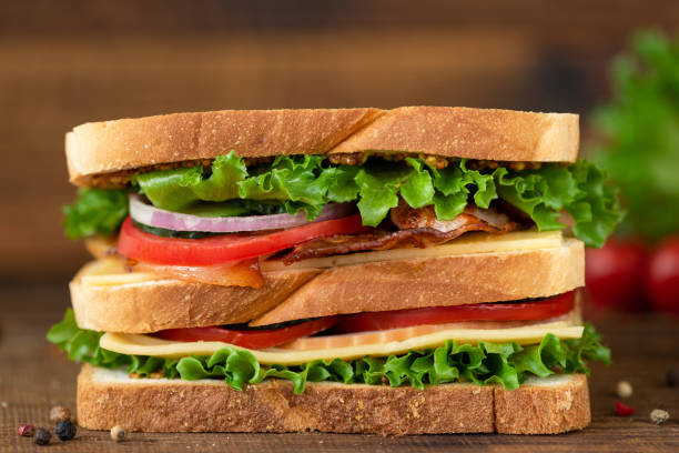 Club Sandwich with bacon cheese tomato lettuce Club Sandwich with bacon cheese tomato lettuce. Tasty unhealthy sandwich double decker SANDWICH stock pictures, royalty-free photos & images