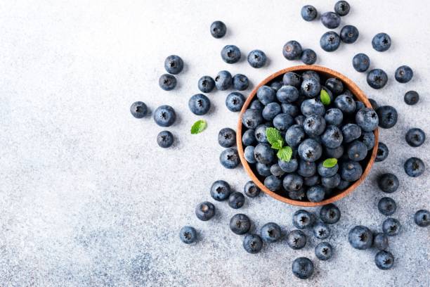 istock Blueberries in bowl on concrete background 1281233491
