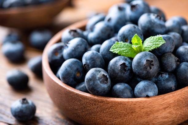 istock Blueberries in a wooden bowl 1281233497