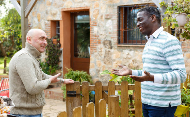 istock Farmer inviting neighbor to courtyard 1281233605