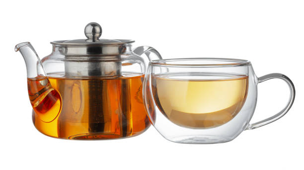 istock Glass teapot and glass cup with tea isolated on white 1281234030