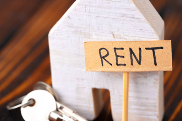 istock Wooden house model and rent tag sign 1281234069