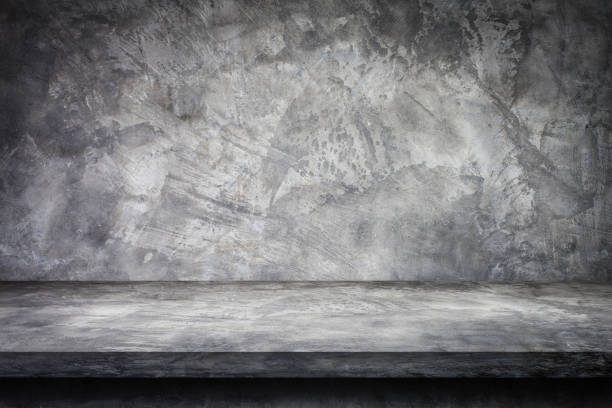 istock Gray plaster concrete shelf table top grunge texture background with concrete wall for product showing. 1281235124