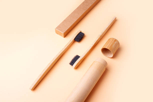 istock Wooden toothbrushes on a gently peach background. Zero waste 1281235499