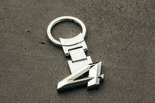 istock Metal number Four car key on dark concrete background 1281235505