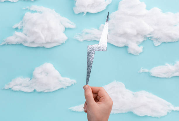 istock Silver lightning figure in child's hands on hand-crafted blue sky background 1281235880