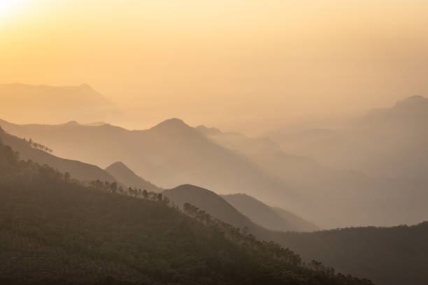 mountain range sunrise at dawn with mist from flat angle mountain range sunrise at dawn with mist from flat angle Image taken at Kodaikanal tamilnadu India from top of the hill. Image is showing the beautiful nature. kodaikanal photos stock pictures, royalty-free photos & images