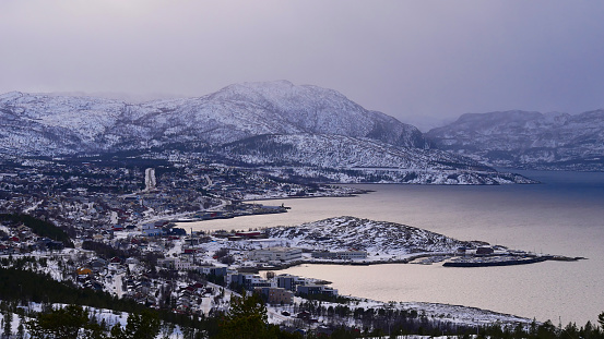 Panorama view over snow-covered city of Alta, Troms og Finnmark, Norway from the peak of Komsa with Altafjord and mountains in winter.